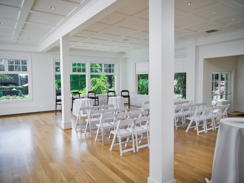 Seats set up in clean rows, minimal decor, in the Tea Room at the Stanley Park Pavilion