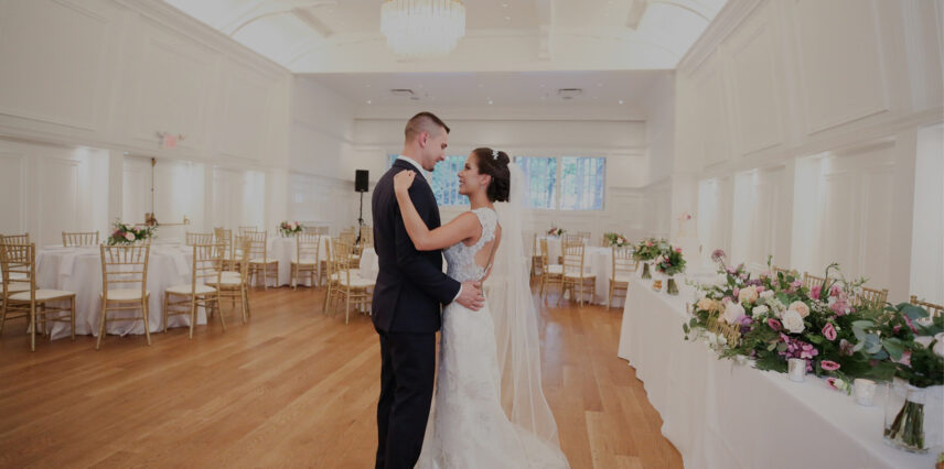 A newlywed couple tour the Ballroom in the Stanley Park Pavilion, set up to serve food to guests