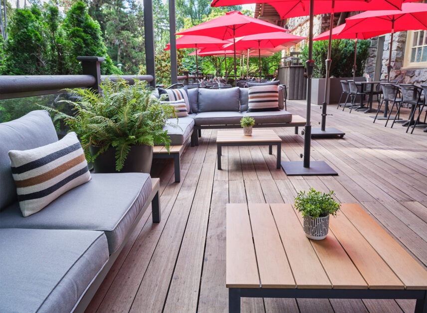 Depicting Stanley's Bar and Grill's patio, empty in the morning light, with umbrella's up.