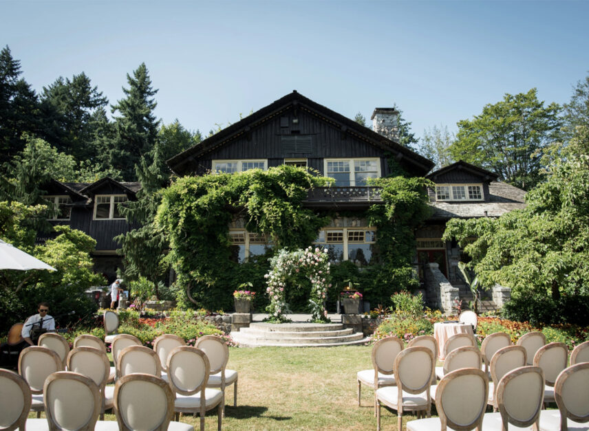 The Stanley Park Pavilion on a summer's day. Blue skies and green grass. Seats line the lawn awaiting the beginning of a ceremony