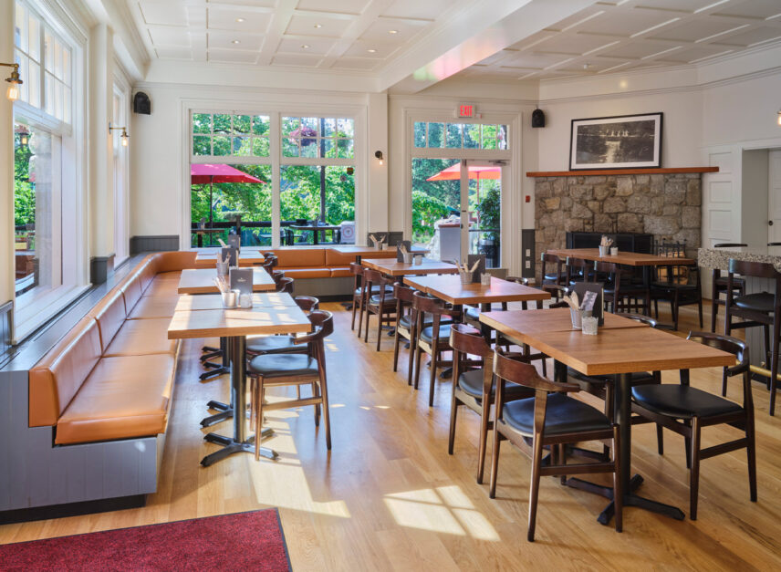 The inside of Stanley's Bar and Grill, lit up in sunshine. Empty seats and tables line the floor, awaiting the first guest of the day.