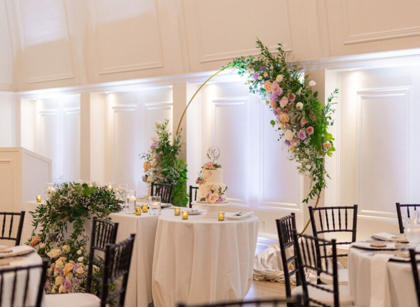 Tables and chairs line the floor of the Stanley Park Pavilion Ballroom in anticipation of the arrival of wedding guests and newlyweds