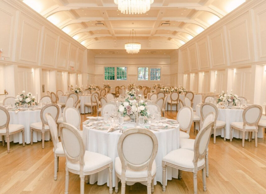 Tables and chairs line the floor of the Stanley Park Pavilion Ballroom in anticipation of the arrival of wedding guests and newlyweds