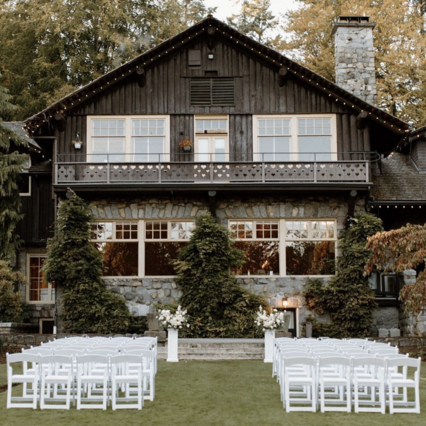 The Stanley Park Pavilion on a fall day. Grey skies and green grass. Seats line the lawn awaiting the beginning of a ceremony
