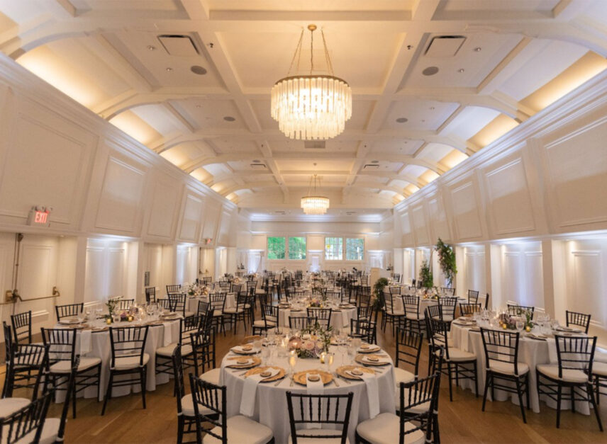 Tables and chairs line the floor of the Stanley Park Pavilion Ballroom in anticipation of the arrival of wedding guests and newlyweds