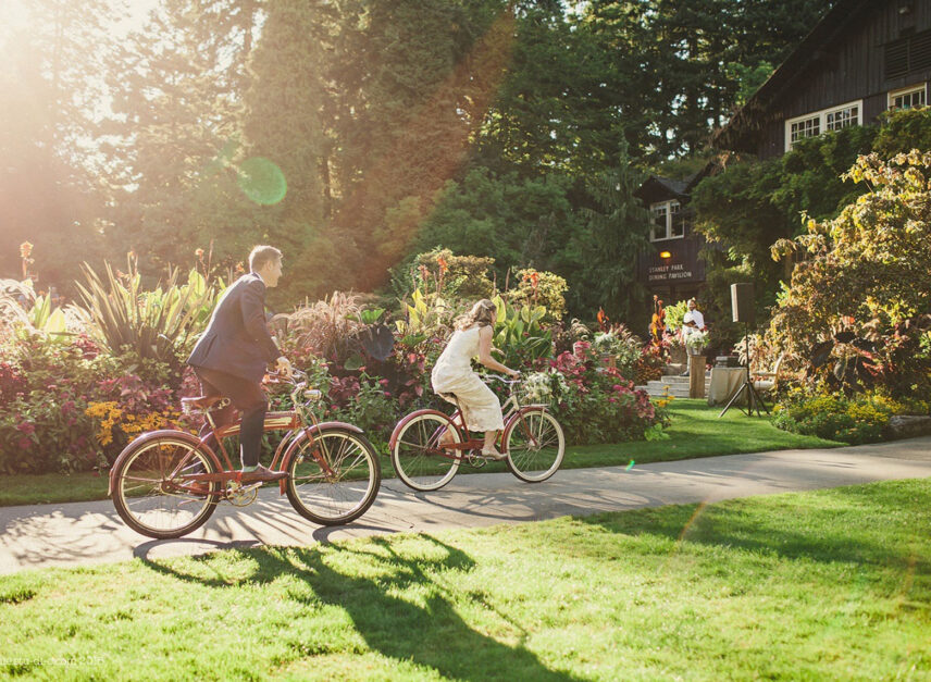A newly married couple on bikes ride around the Pavilion's grounds.