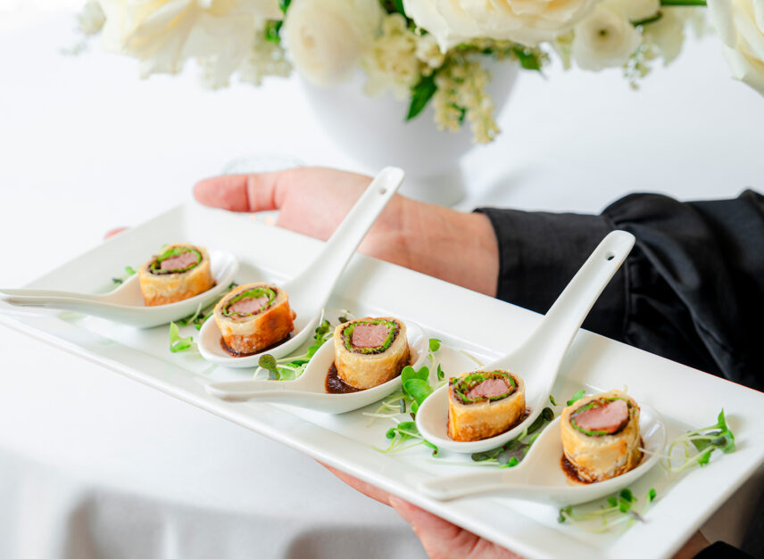A set of appetizers is presented, with a wedding-style backdrop