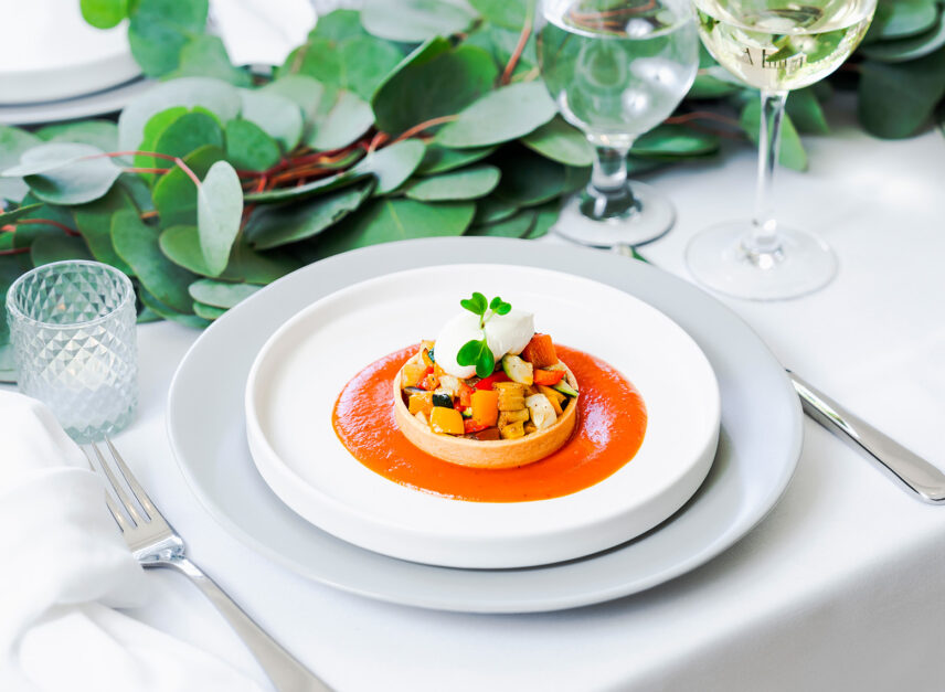 An appetizer of assorted vegetables, is placed on a pure white linen