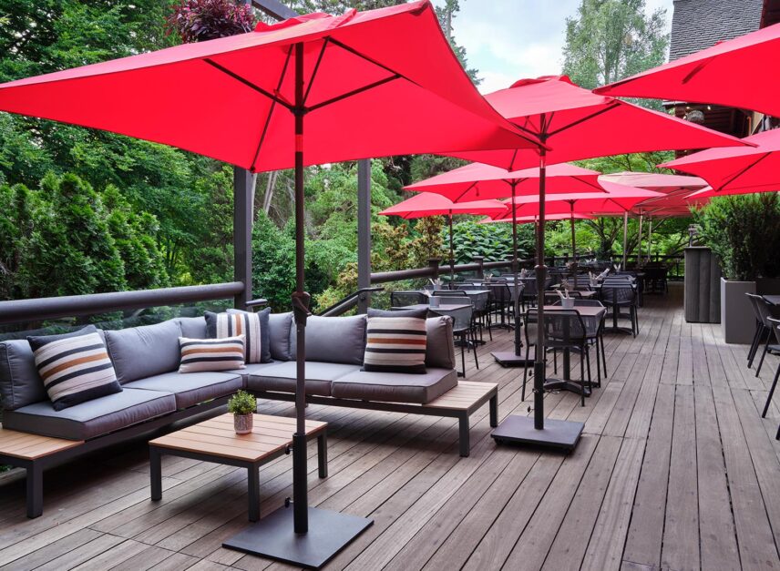Depicting Stanley's Bar and Grill's patio, empty in the morning light, with umbrella's up.