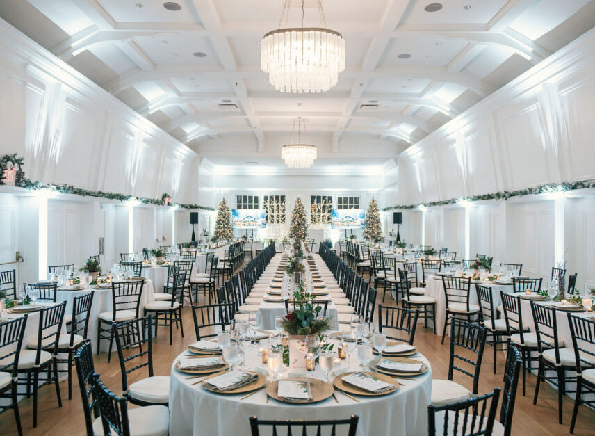 An image of the Lord Stanley Ballroom decorate in festive hoiday decor and set up with decorated tables and chairs for a corporate holiday party