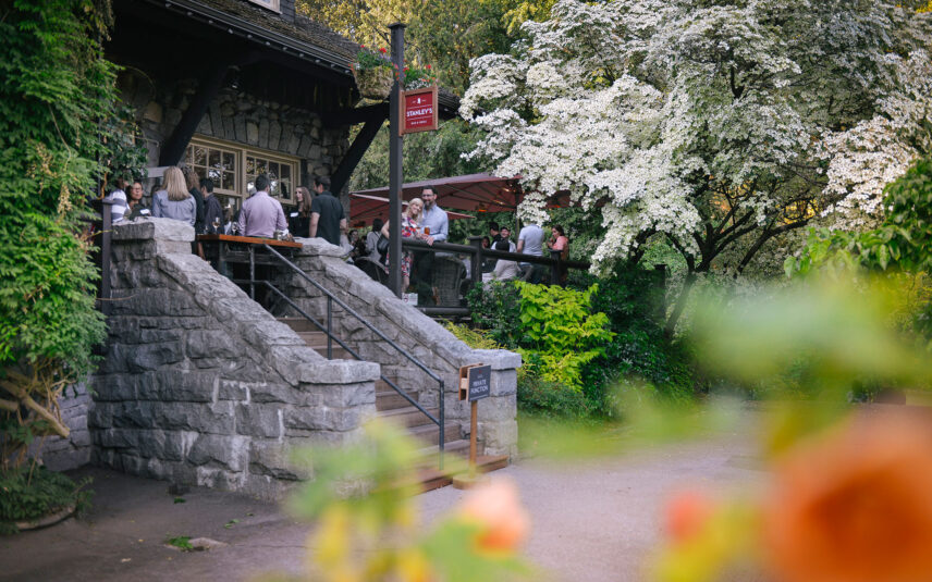 A group of people enjoying the Cherry Blossoms on the patio of Stanley's Bar and Grill